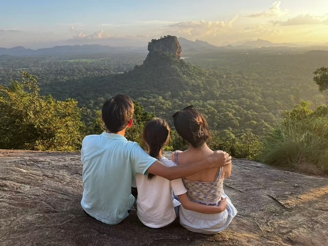 Family watching the sunset over Sigiriya from Pidurangala rock