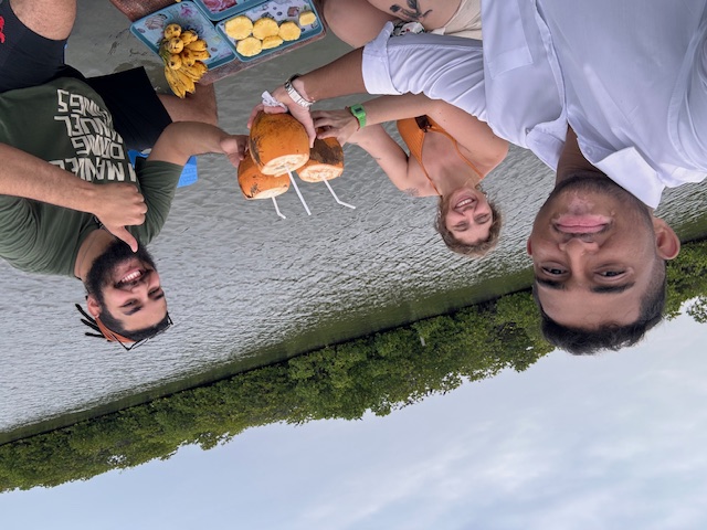 Guests toasting with king coconuts on a mangrove backwater safari