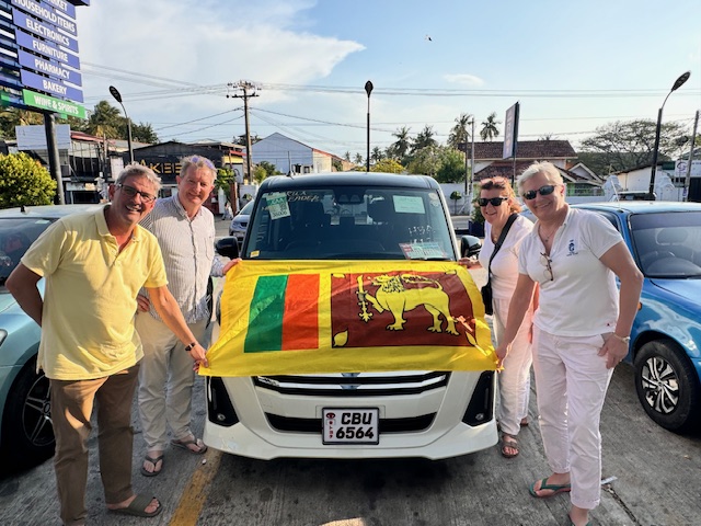 Guests with the Sri Lankan flag by their private tour van